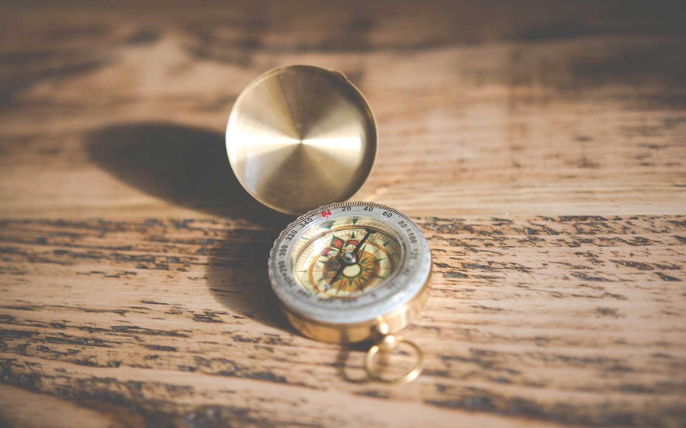 Compass on wood table.