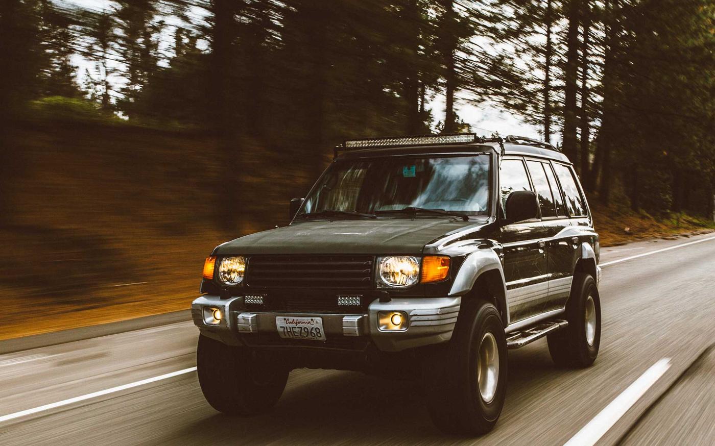 SUV driving down highway.